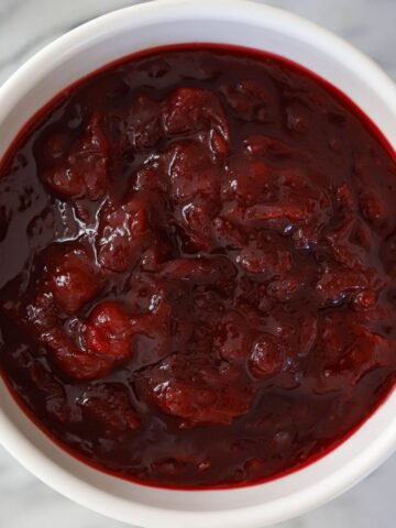 homemade cranberry sauce in a small white bowl.