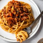 dish of linguine topped with bolognese sauce