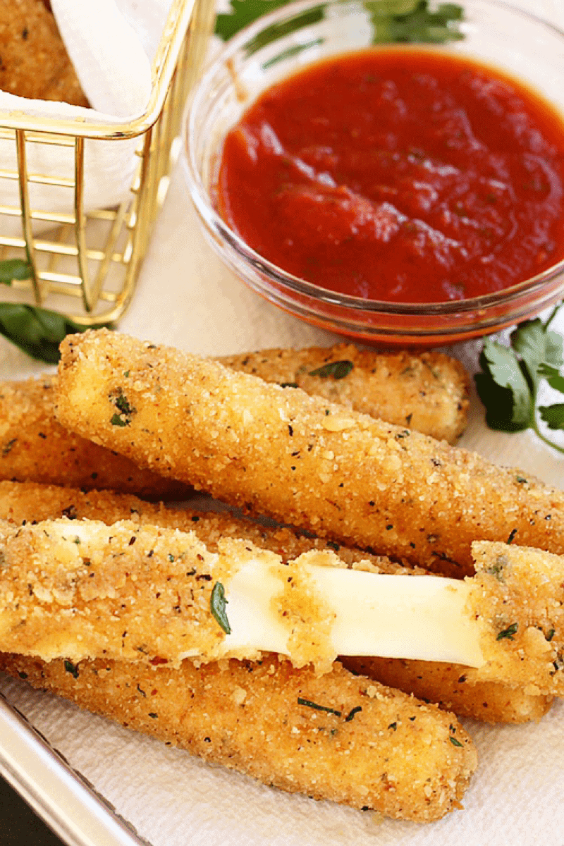 Golden crispy mozzarella stick pulled apart to show cheesiness.