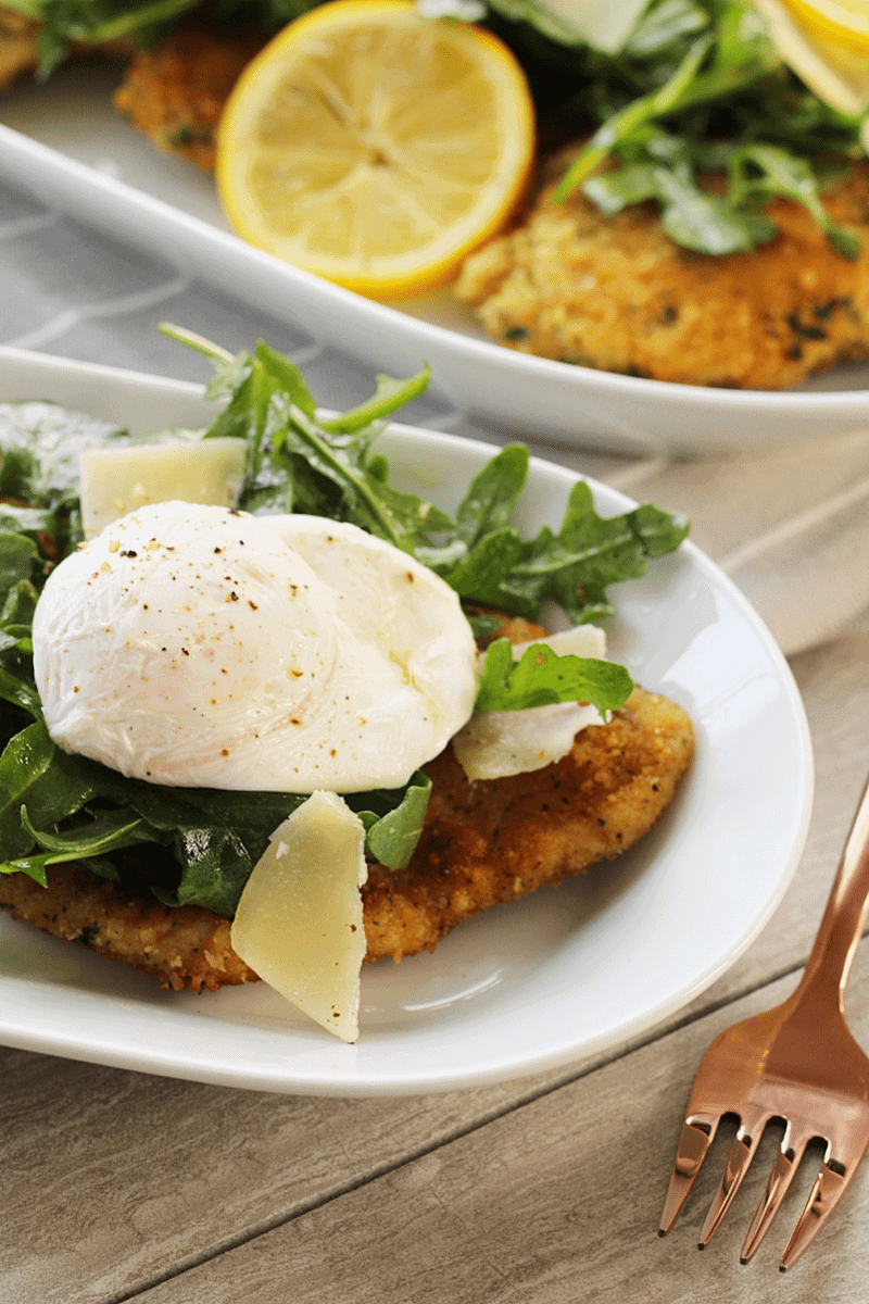 Golden breaded chicken breast topped with arugula salad, shaved parmesan cheese and a poached egg