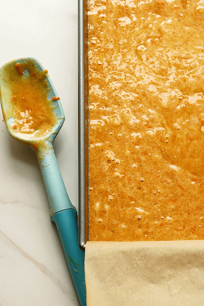 carrot cake batter in a 9x13-inch metal baking pan