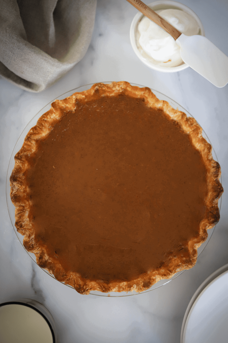 overhead view of a fully baked pumpkin pie with no cracks
