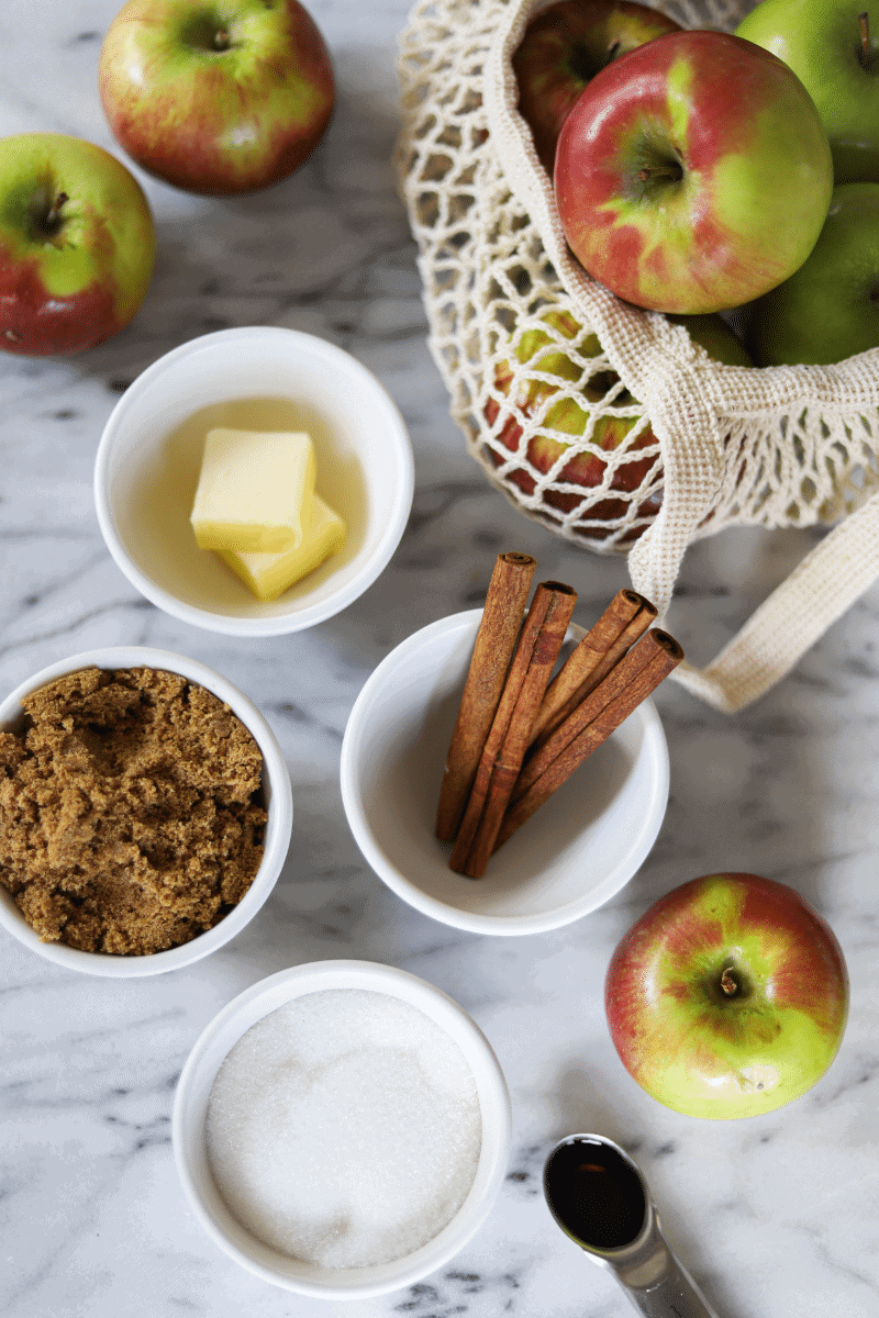 This photo is a snapshot of the key ingredients needed to make apple pie filling-apples, a few tablespoons of butter, white and brown sugar, cinnamon and vanilla extract. Not all ingredients in the recipe are shown.