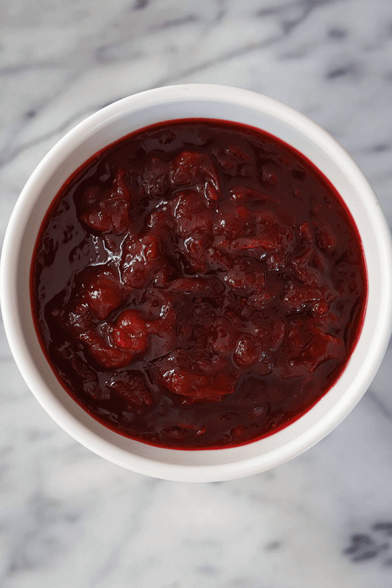 Homemade spiked cranberry sauce in a white bowl 