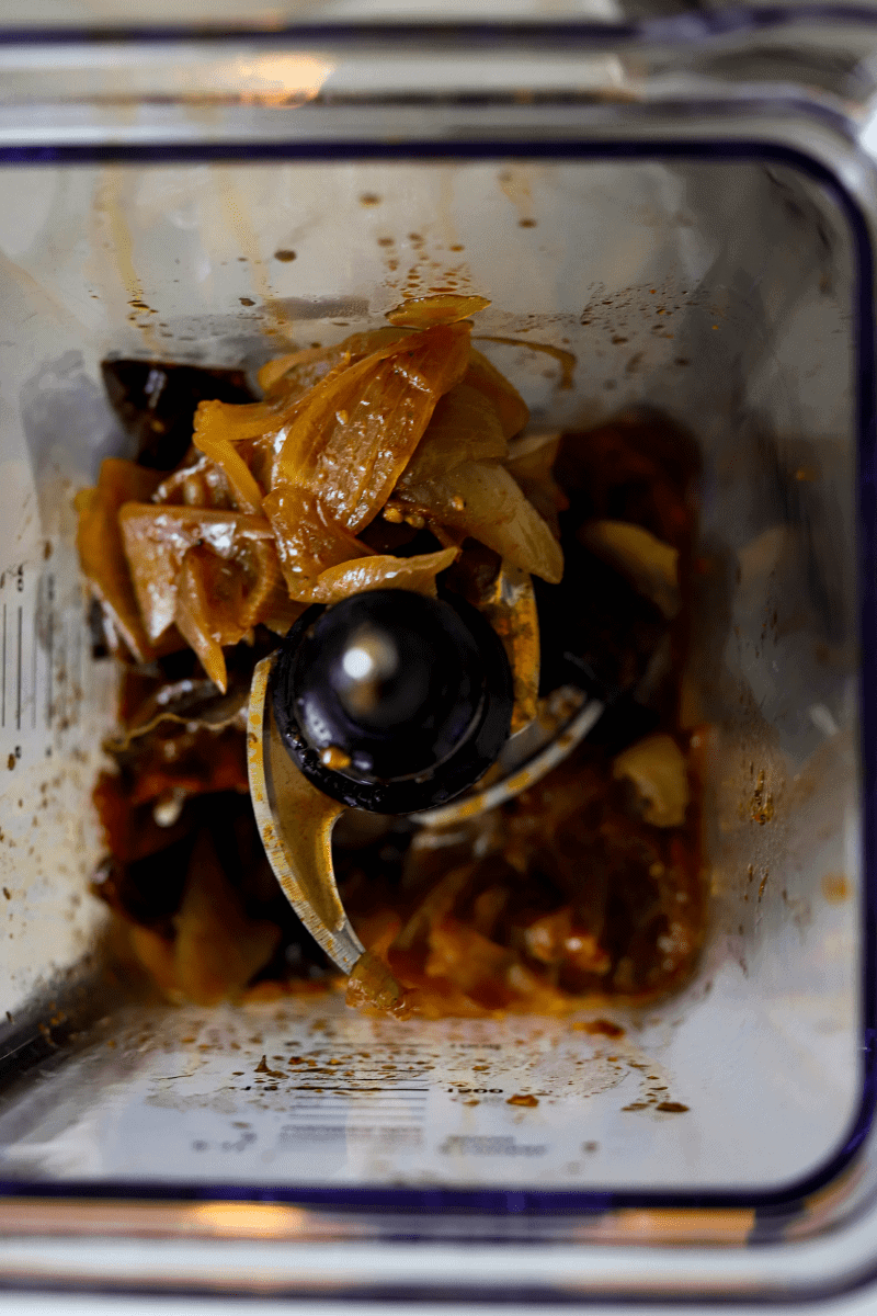 Stewed onions, pepper and tomatoes in a blender and going to be pulsed to make birria