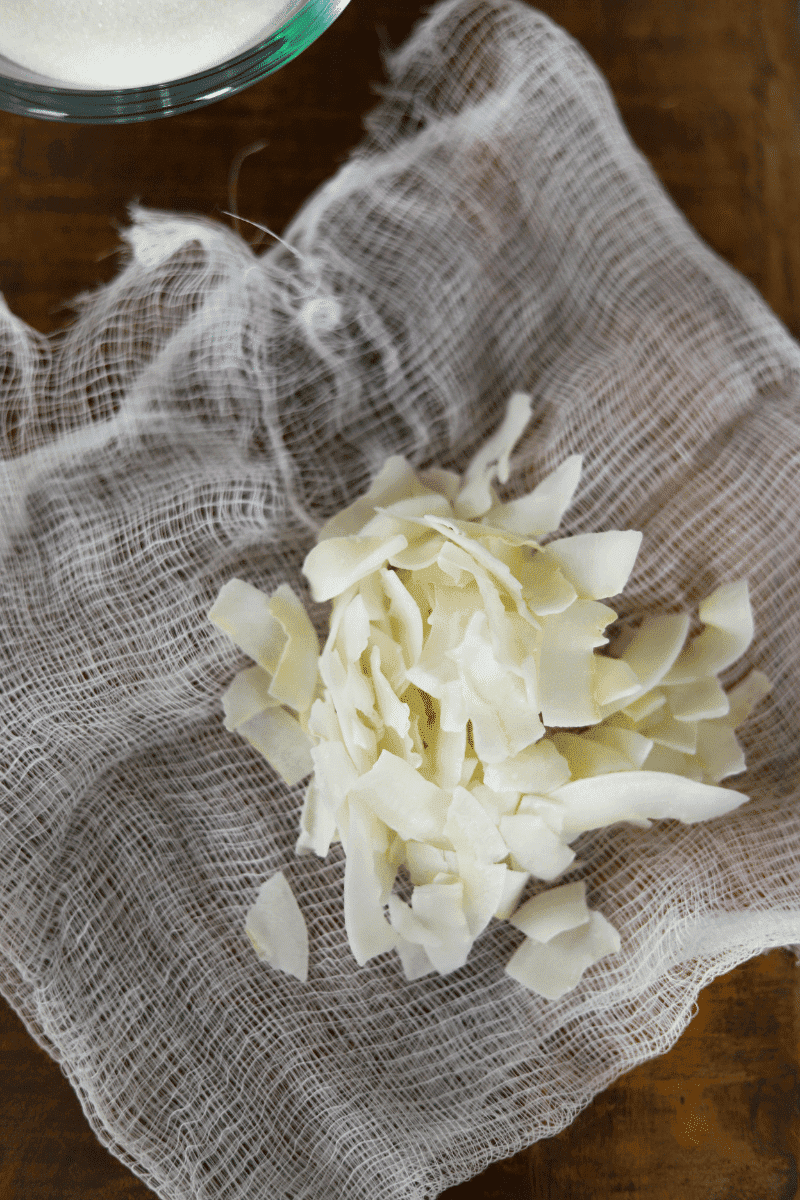 This is an overhead photo of coconut flakes placed on a cheesecloth.