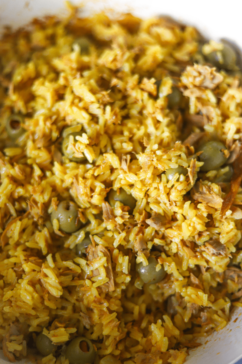 Close-up photo of Cape Verdean rice with tuna (arroz de atum) that's been cooked and fluffed with a fork.