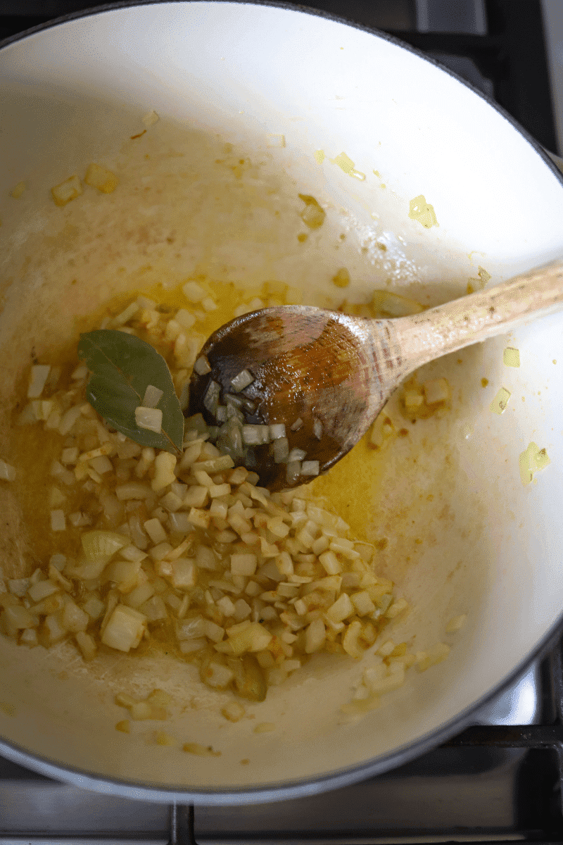 This is a photo that demonstrated the step of cooking the chopped onions and bay leaf prior to making the base of the caldo verde.
