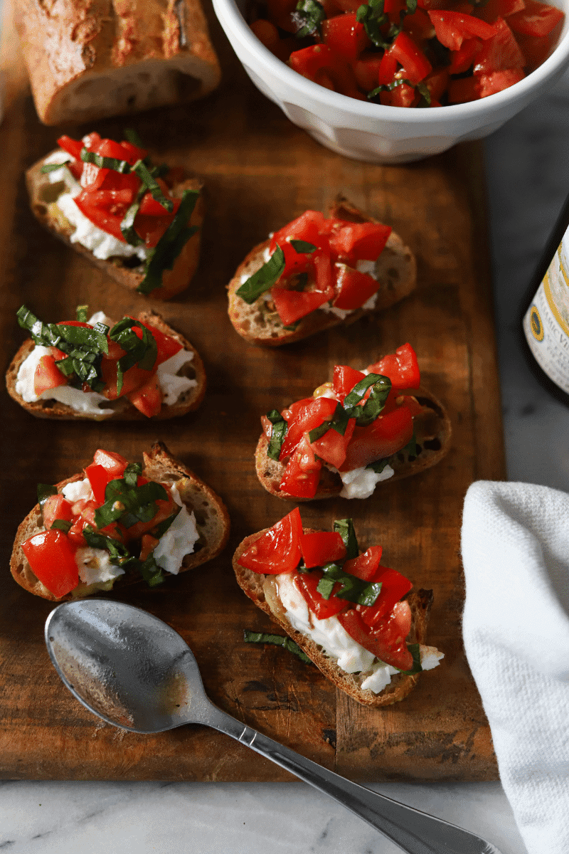 bruschetta topped with burrata cheese, tomatoes and fresh basil