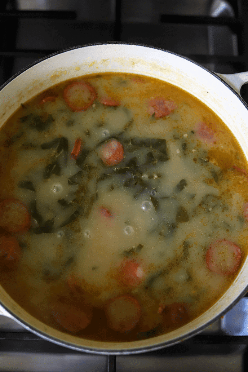 pot of caldo verde with linguiça added to the soup