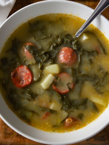 bowl of caldo verde in a white bowl