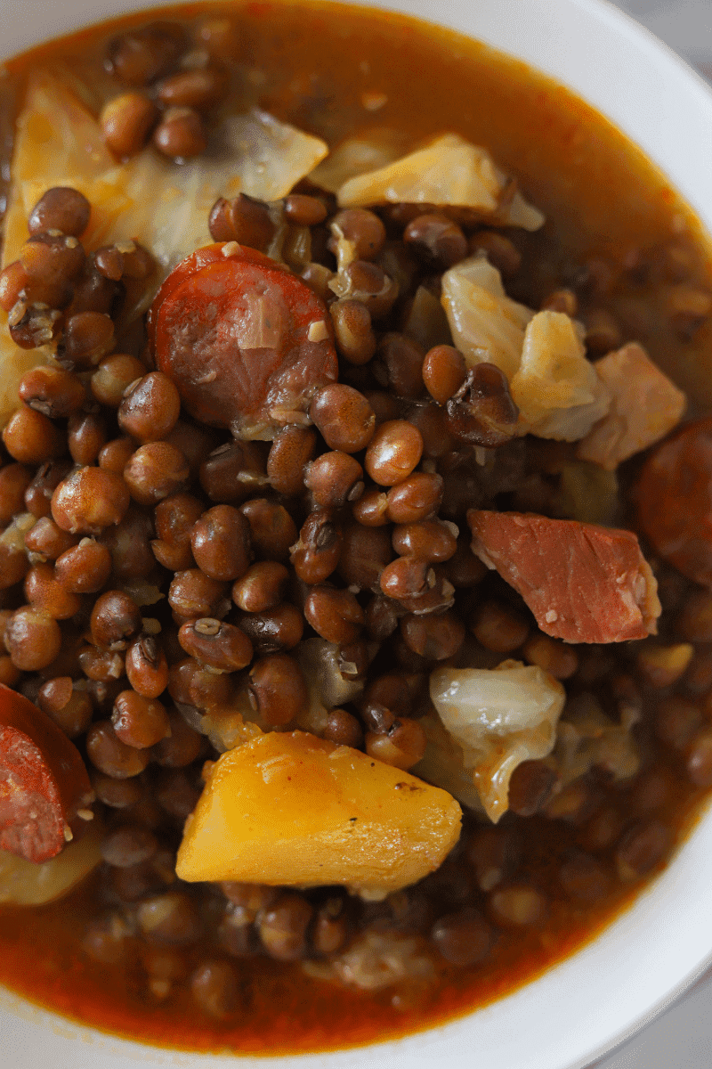 Close up of Cape Verdean stewed pigeon peas (feijão congo) with cabbage, squash and linguiça