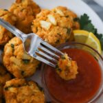 Baltimore style crab cakes shown with cocktail sauce