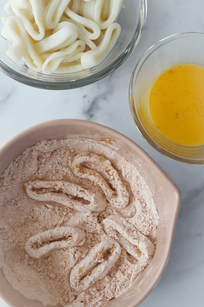 Overhead photo of squid rings, egg wash and dredging flour