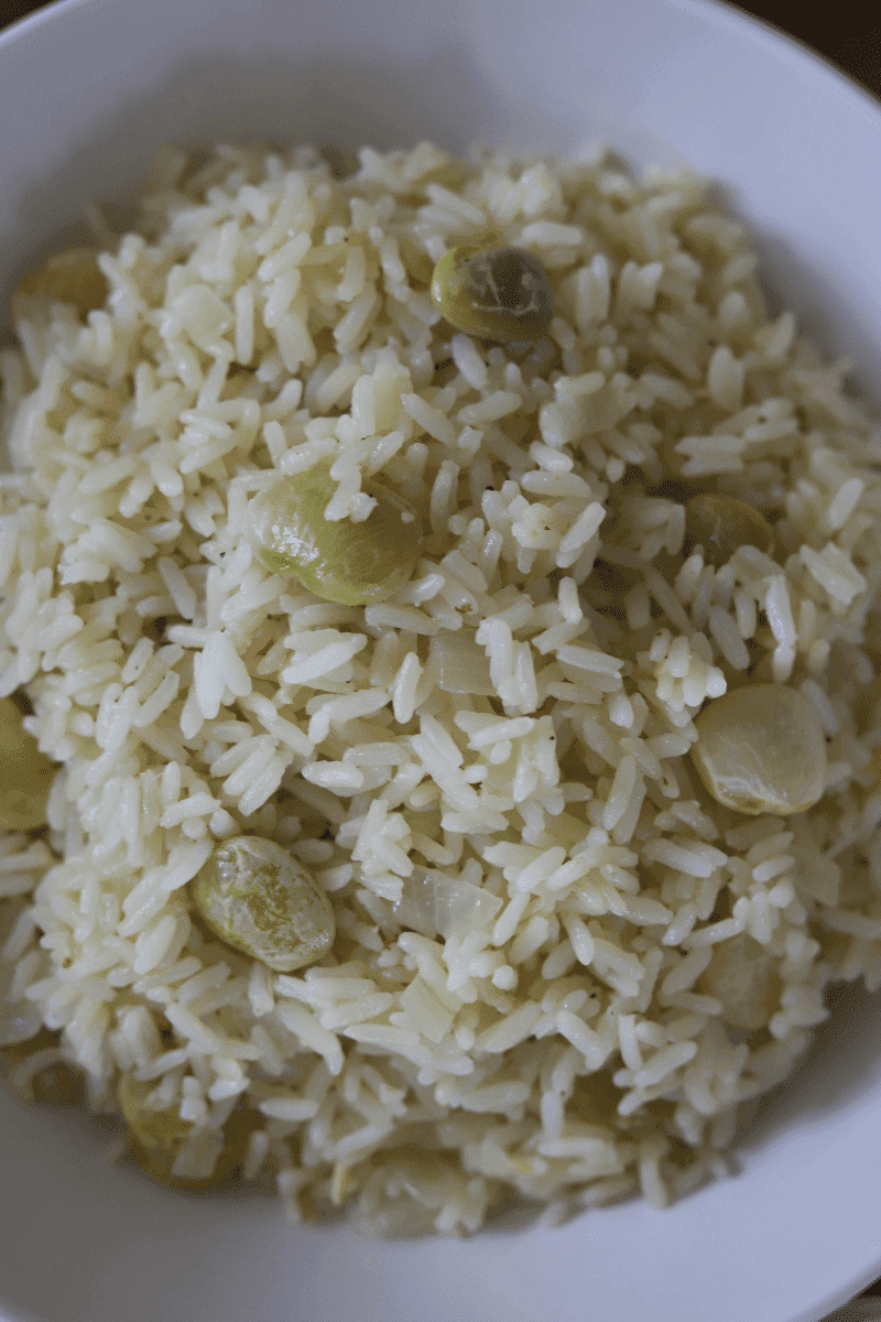 Close up photo of Cape Verdean style white rice with lima beans in a bowl