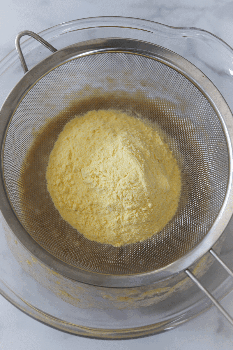 bowl of mashed bananas, sifted cornmeal and sifted flour to make Cape Verdean banana fritters (brinhola)