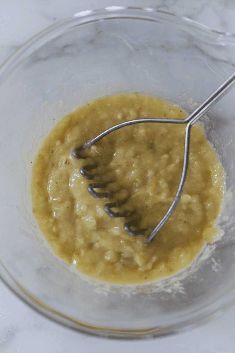 mashed bananas in mixing bowl for brinhola (banana fritters) recipe