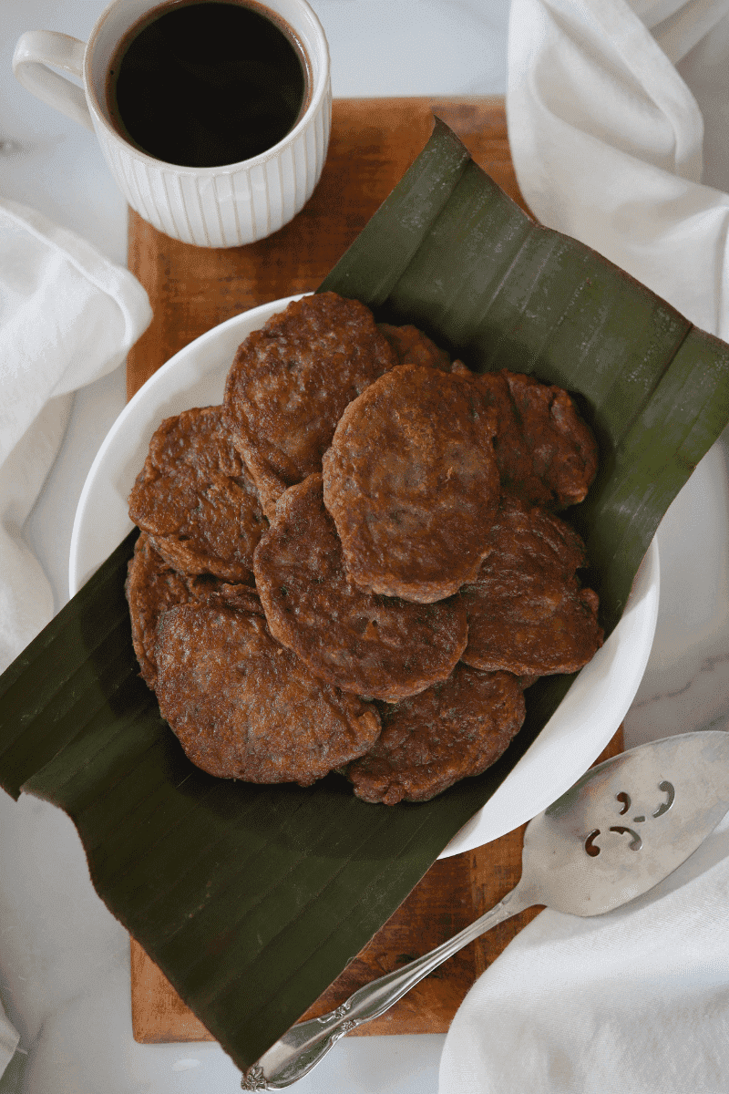 Cape Verdean banana fritters (brinhola) on a plate served with cup of coffee