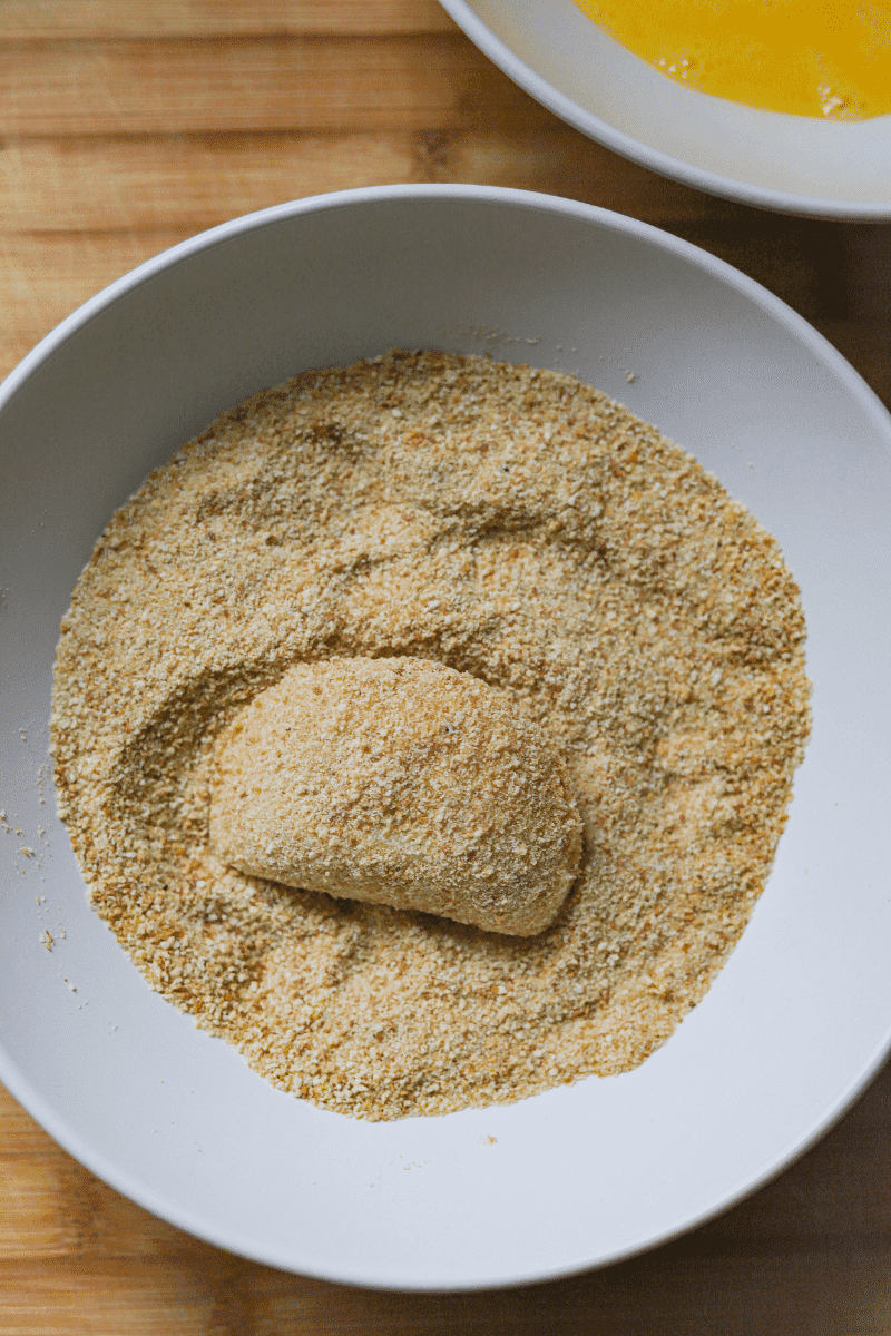 single rissol in a plate of breadcrumbs