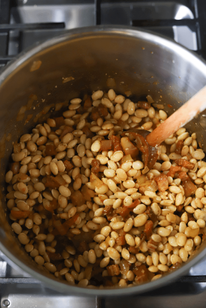 process shot showing beans added to pan for feijoada
