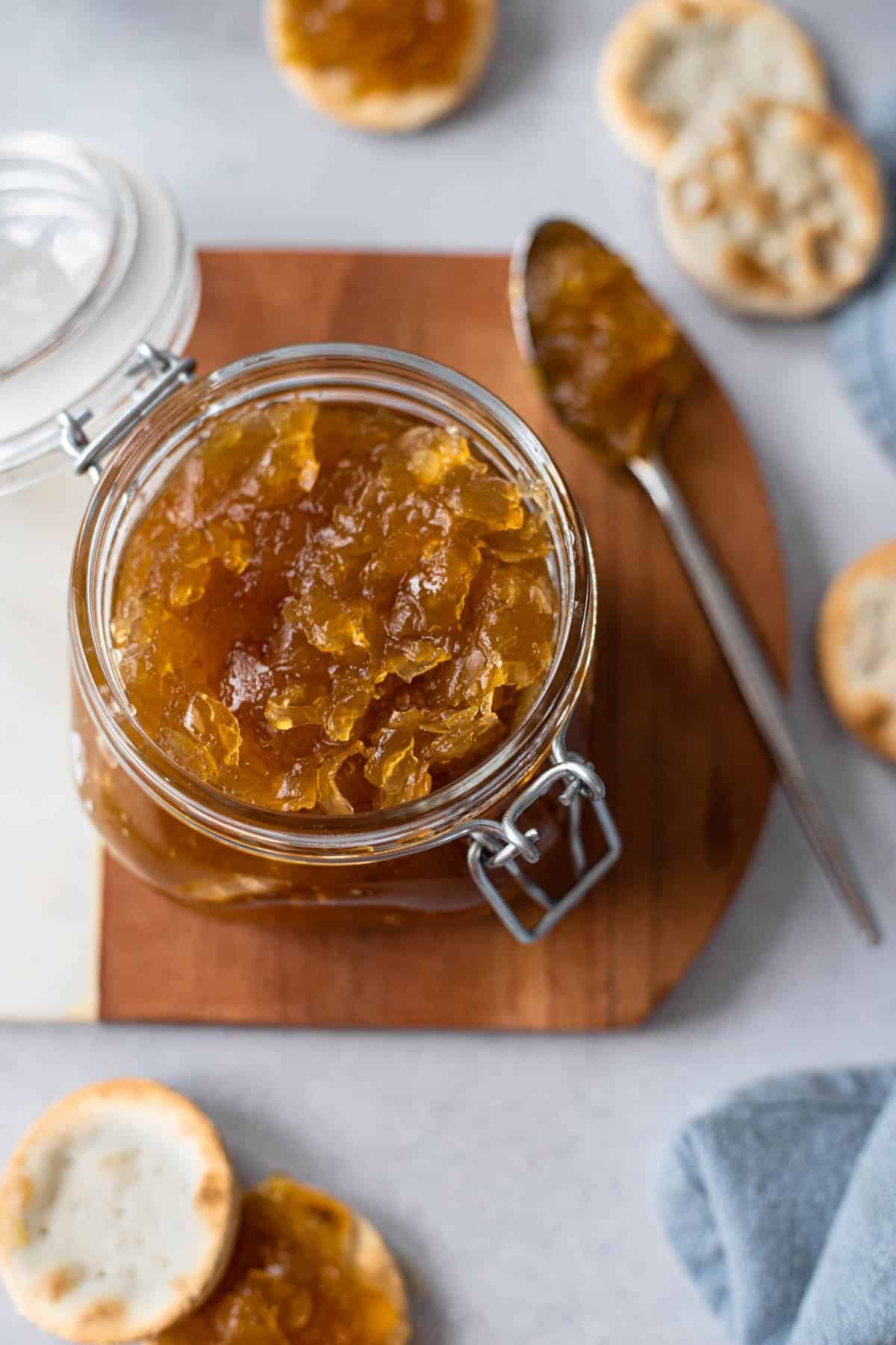 green papaya jam in a mason jar shown with water crackers