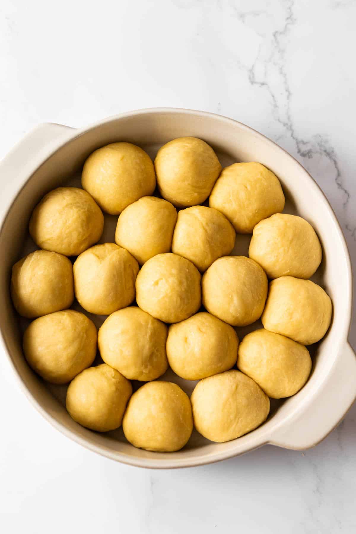 unbaked Portuguese sweet rolls in baking dish