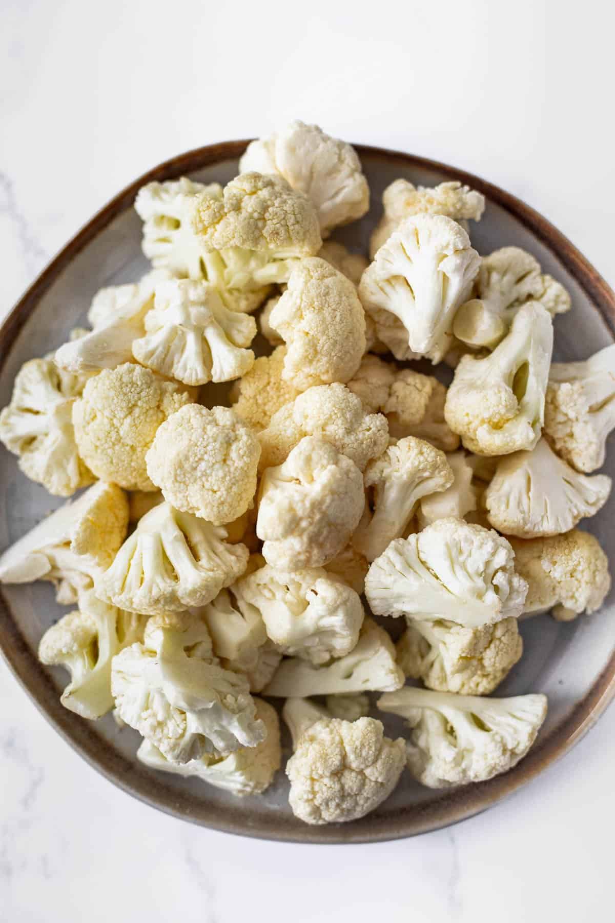 Plate of cauliflower florets for vegan buffalo wings