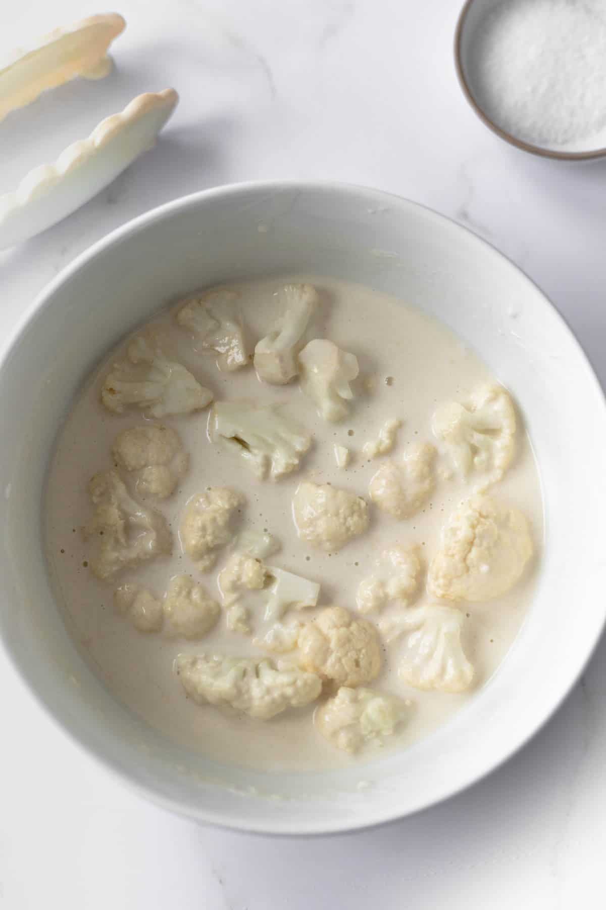 cauliflower florets in tempura batter in a bowl