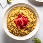 bowl of Dominican mangu topped with red onions.