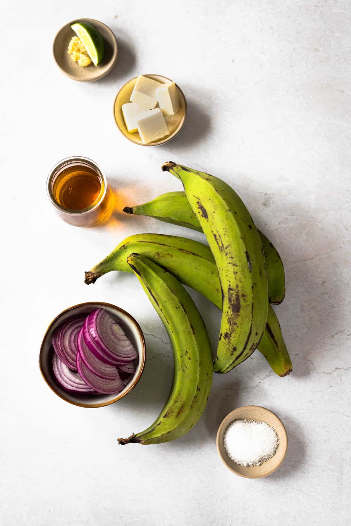 ingredients needed to make Dominican mangu - green plantains, butter, apple cider vinegar, salt and red onions