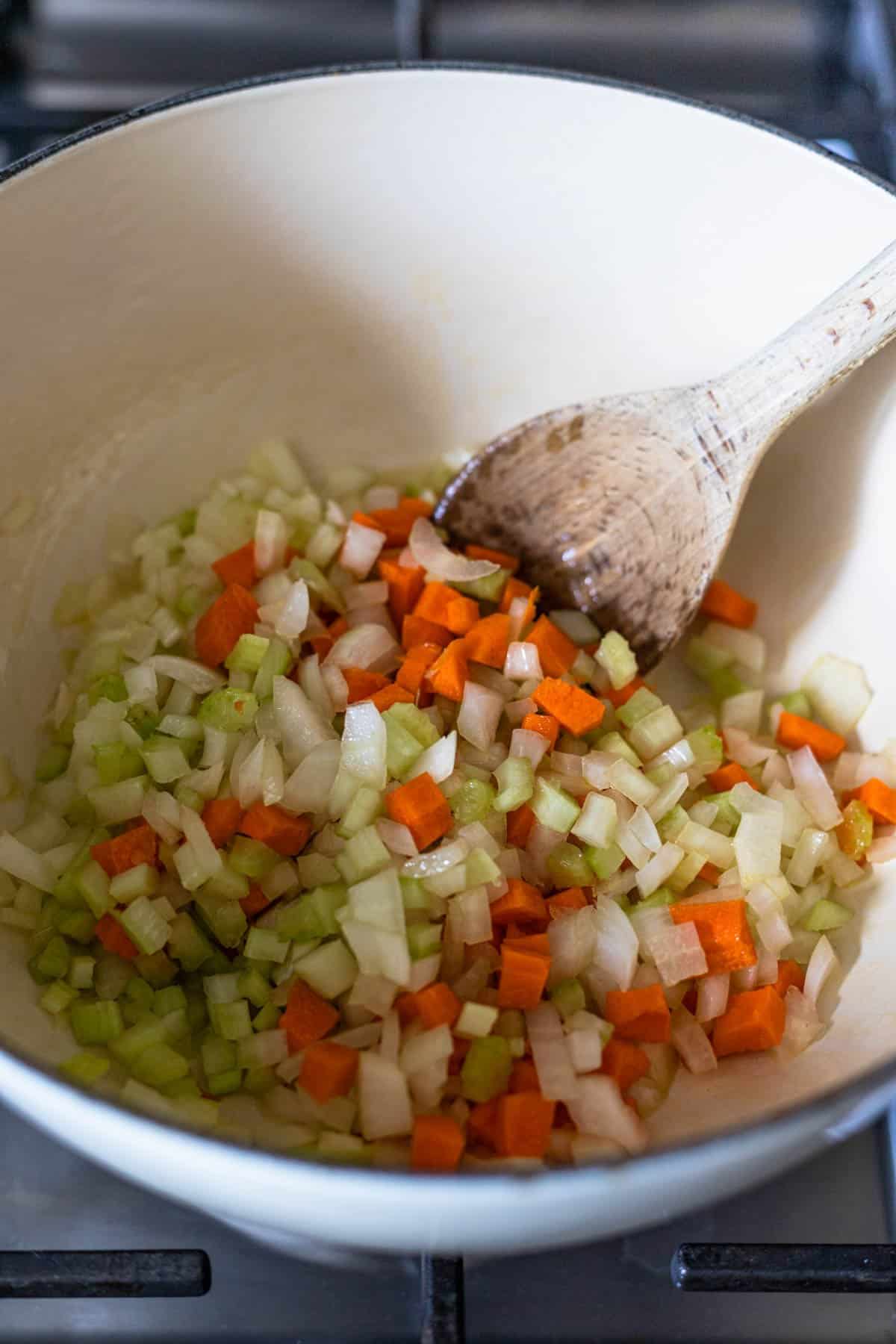 sauteed carrots onions and celery in a pot
