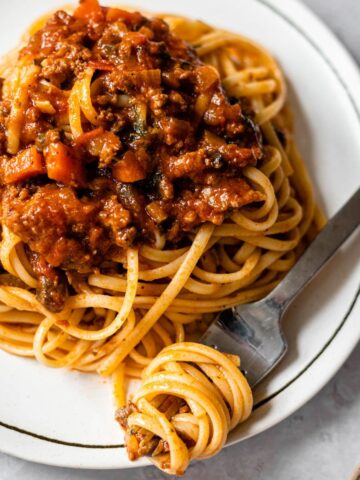 dish of linguine topped with bolognese sauce