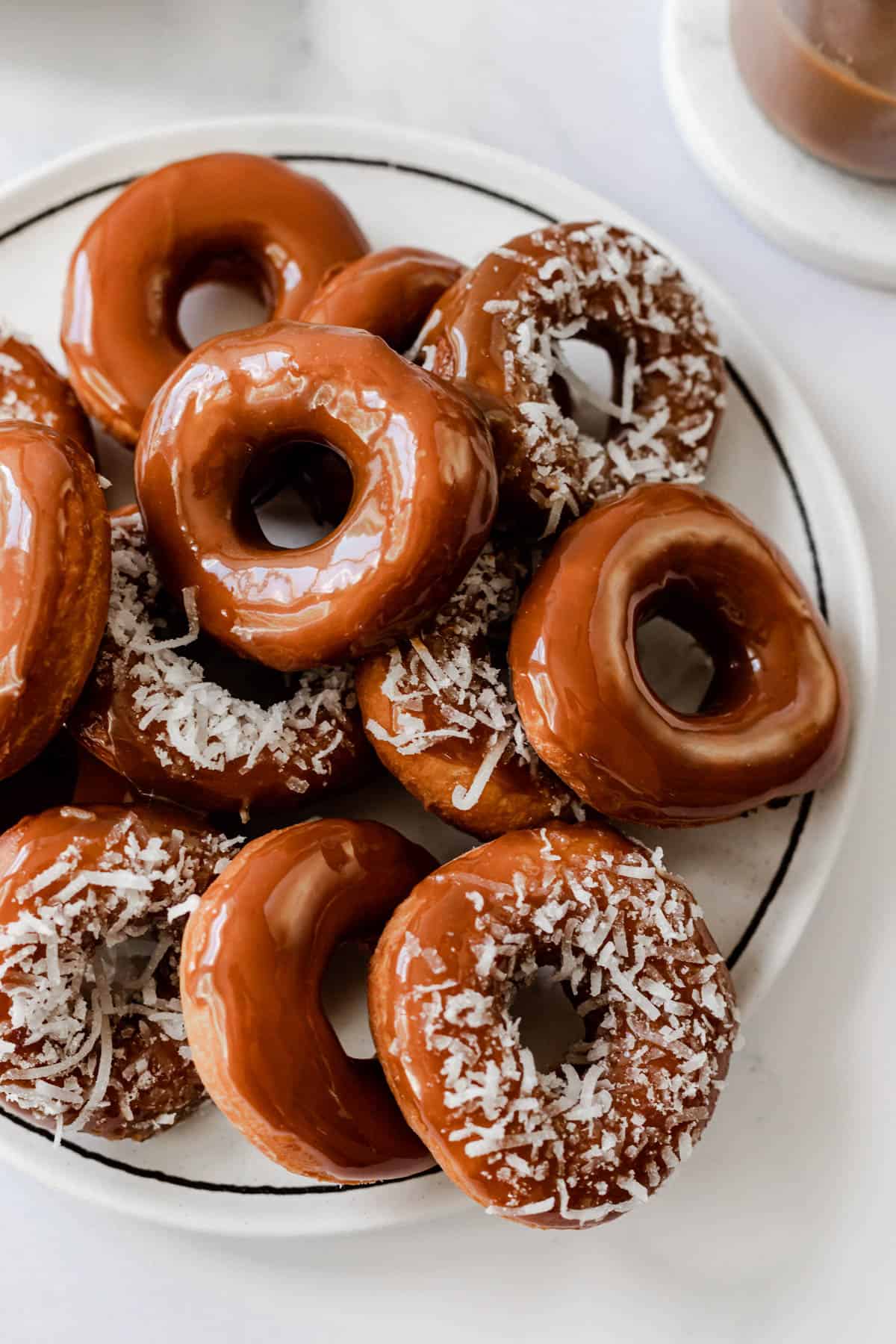 plate of Cape Verdean style donetes topped with caramel and shaved coconut