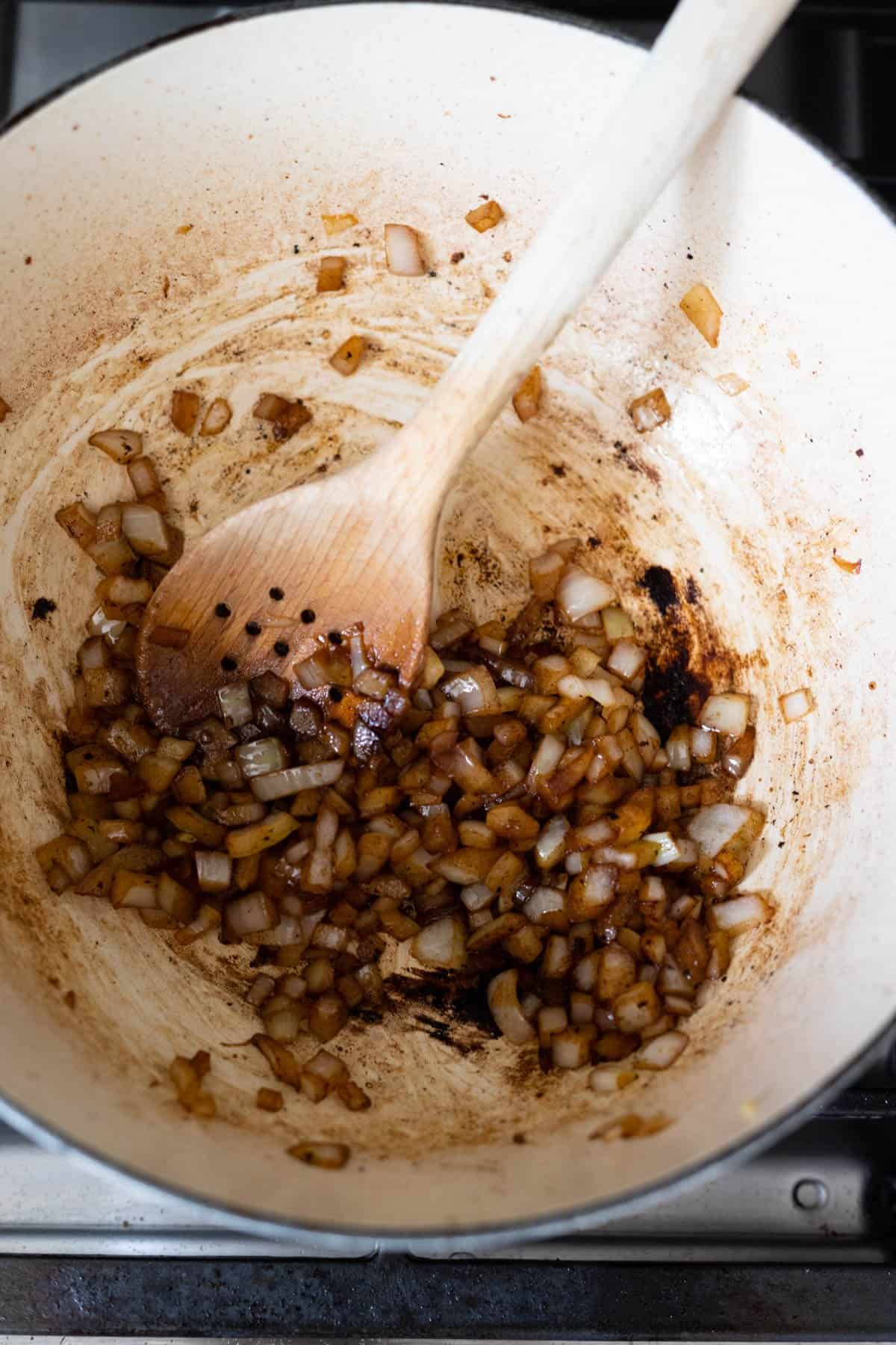 process photo showing onions deglazing the pan