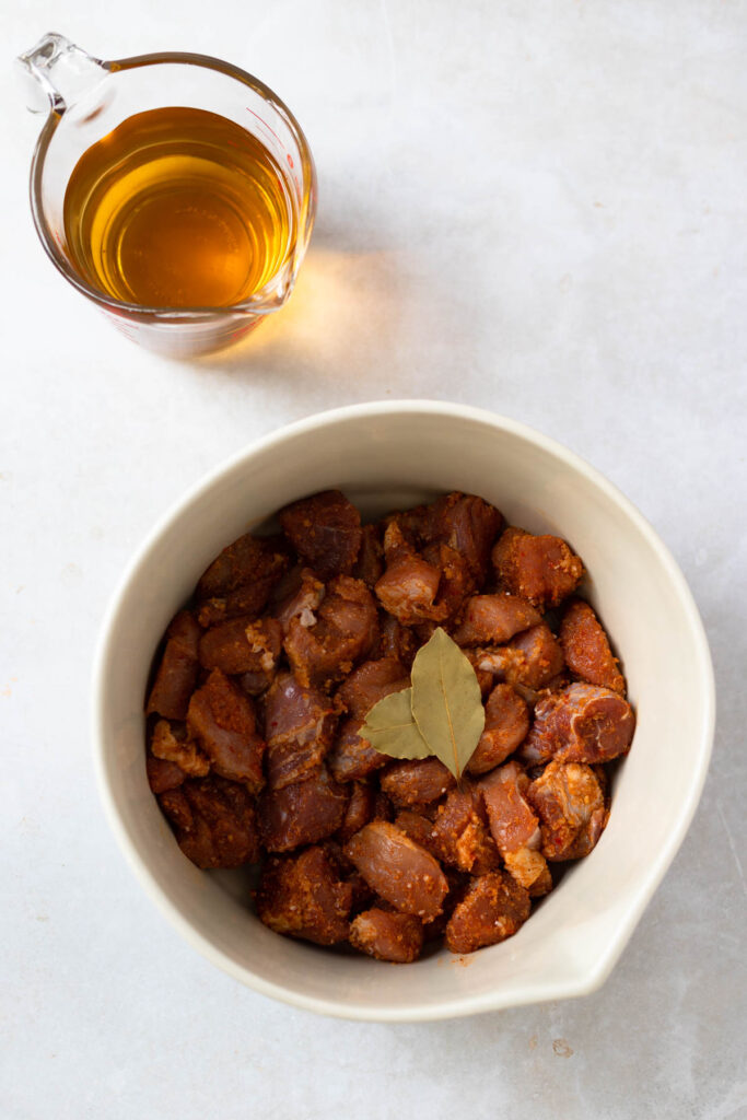 seasoned pork in a bowl in preparation for carne alentejana