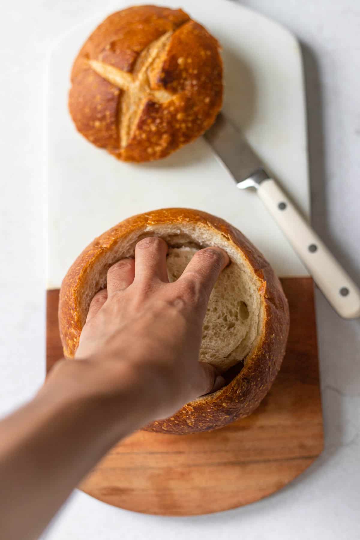 pulling out the inside of a bread bowl