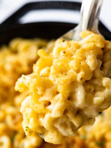 spoonful of creamy cast iron mac and cheese made with 5 cheeses.