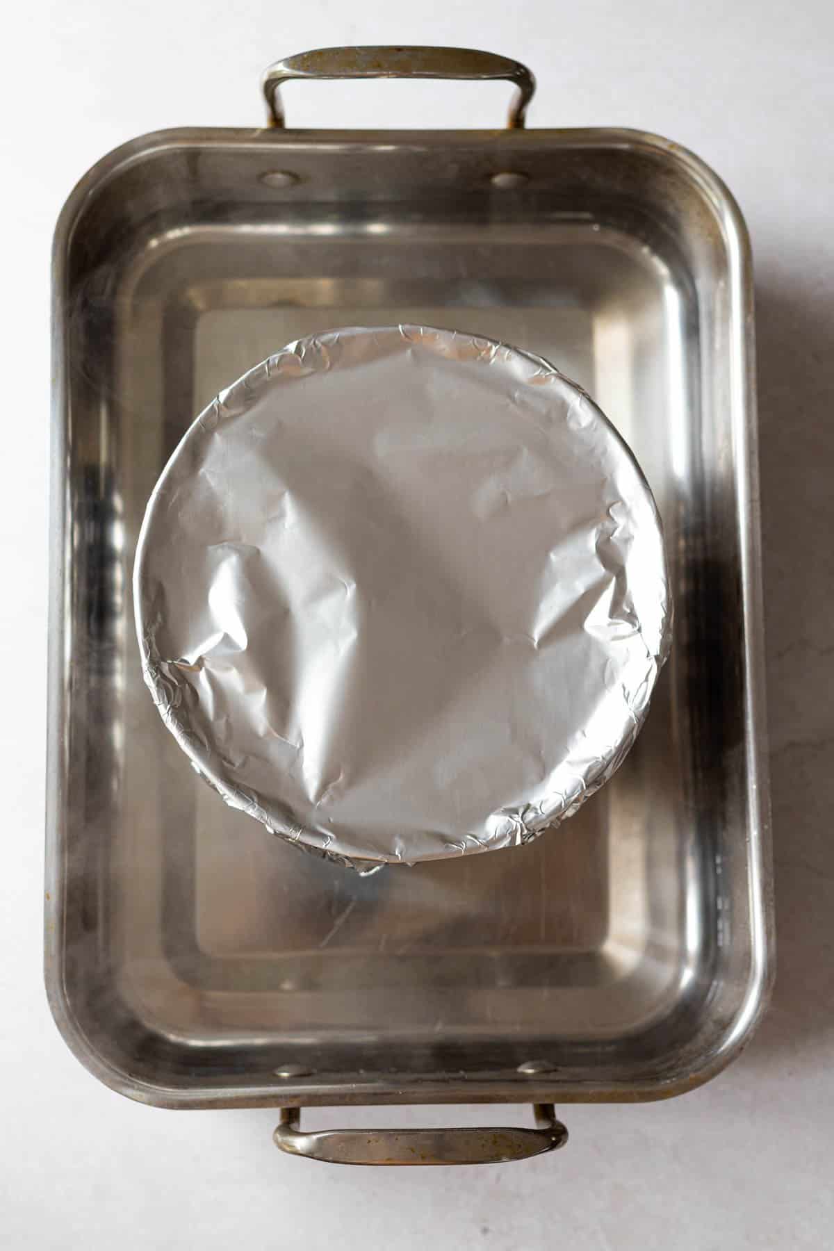 flan mold placed in a water bath