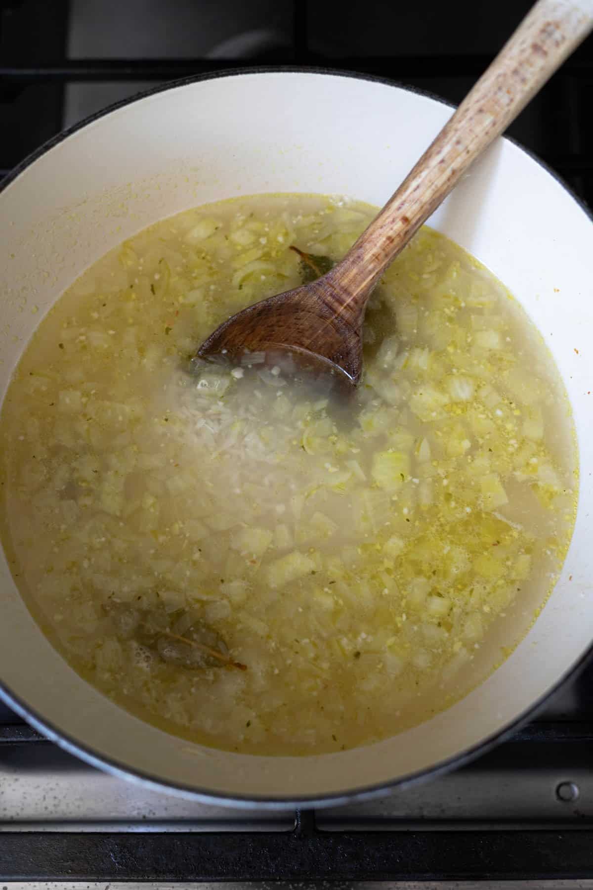 white rice in a pot of seasoned cooking liquid