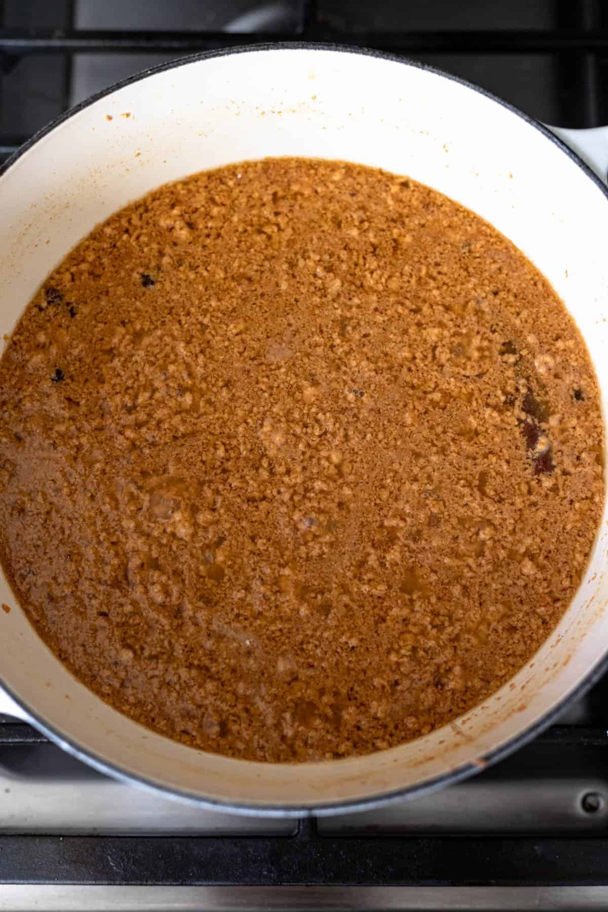 curdled milk combined with melted sugar in a pot that has turned darker in color