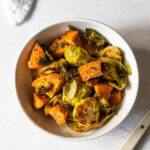 roasted brussels sprouts and sweet potatoes in a bowl