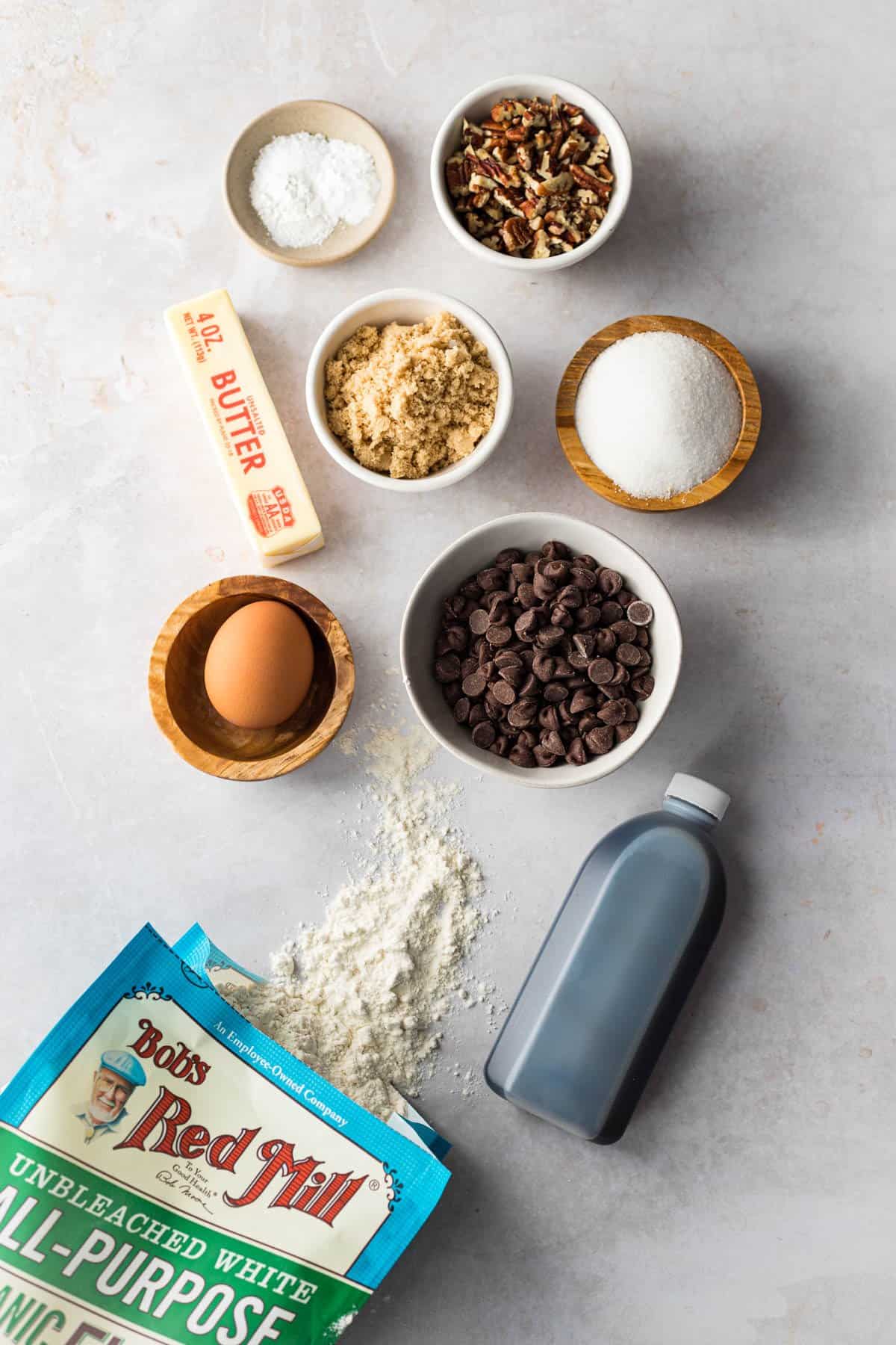 chocolate chip pecan cookie ingredients - flour, vanilla extract, egg, brown and white sugar, butter, chocolate chips and pecans.