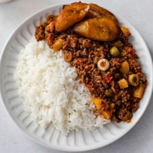 carne molida (beef picadillo) on a white plate served with rice.