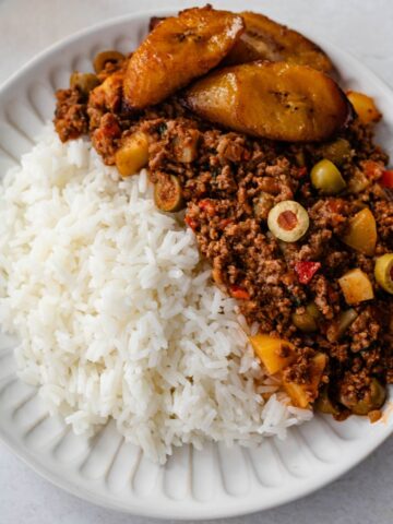 carne molida (beef picadillo) on a white plate served with rice.