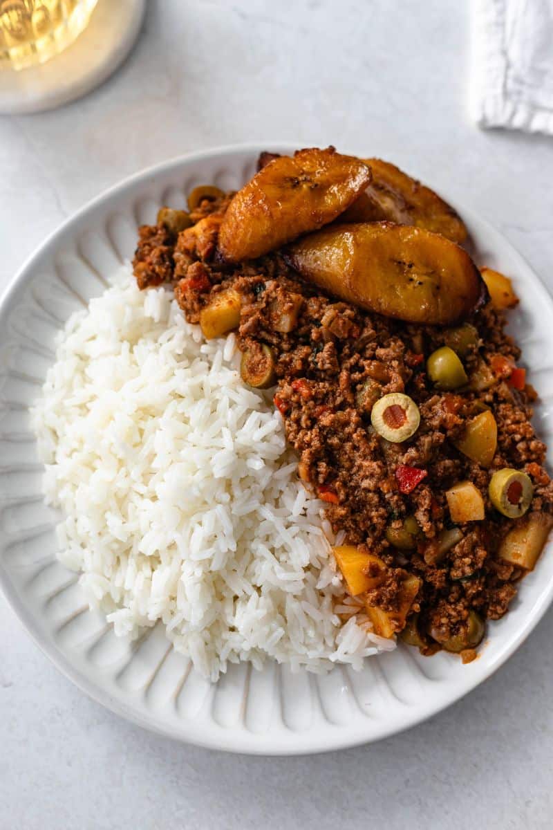 carne molida (beef picadillo) served with rice on a white plate.