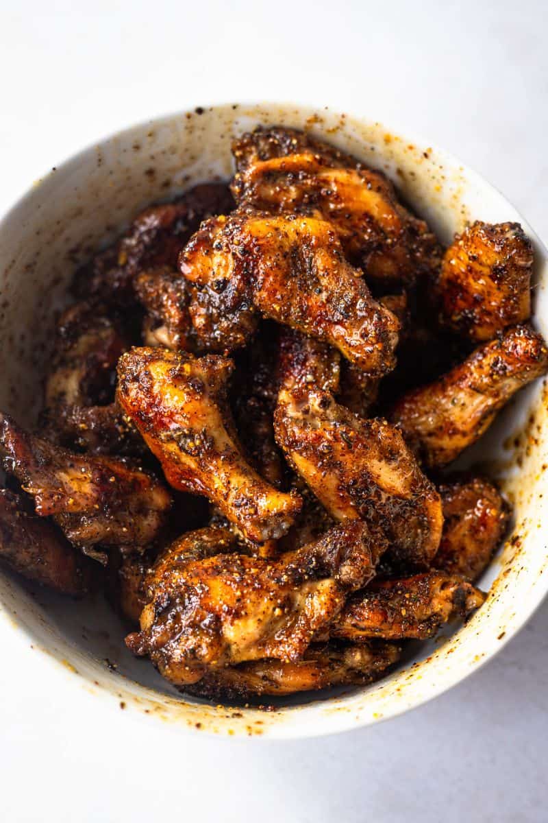 glazed honey lemon pepper wings in a white bowl.