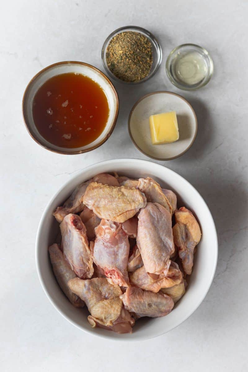 recipe ingredients for honey lemon pepper wings - party wings, honey, butter, lemon pepper seasoning and neutral oil.